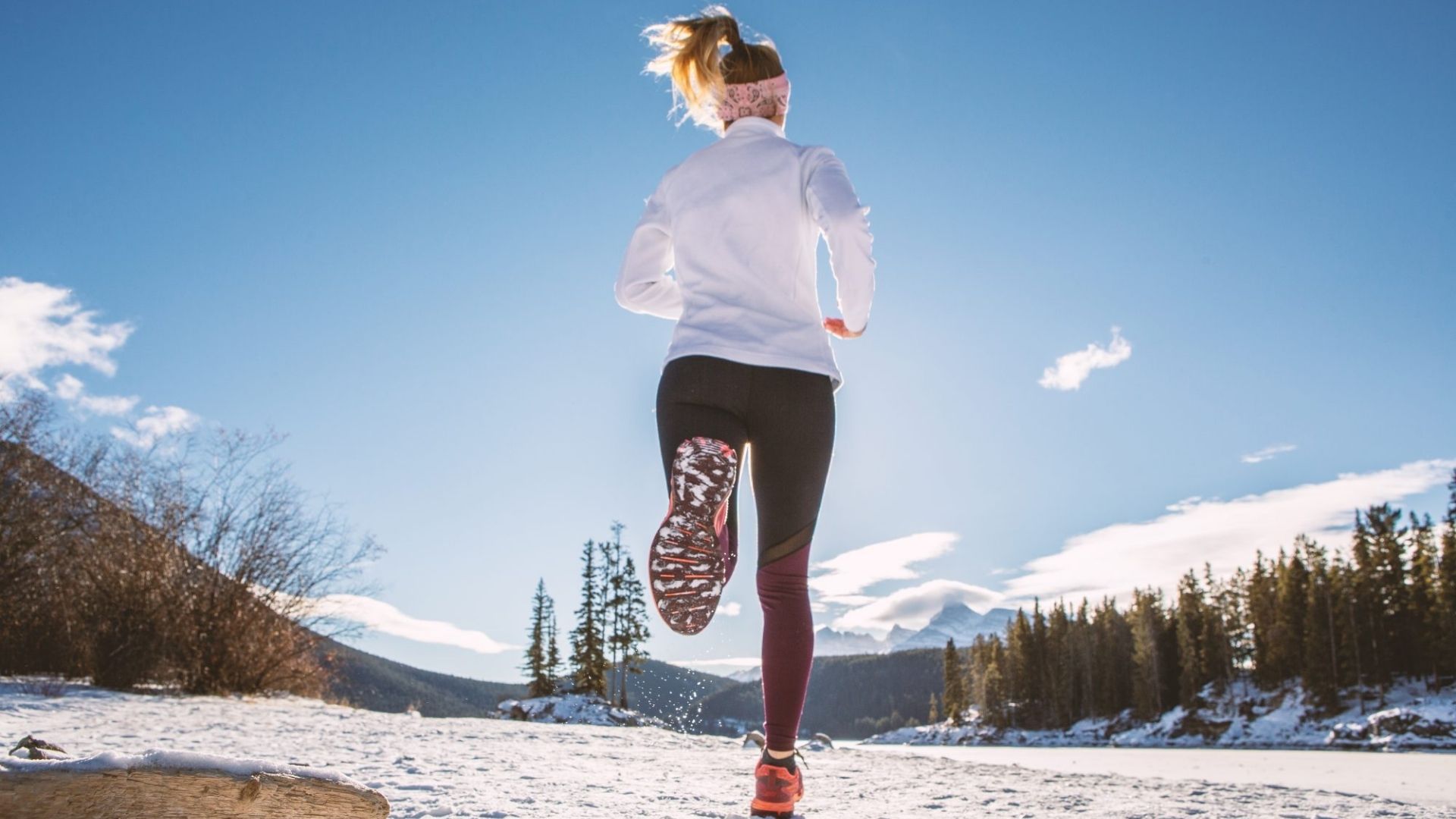 Mulher fazendo exercícios físico, corrida na neve