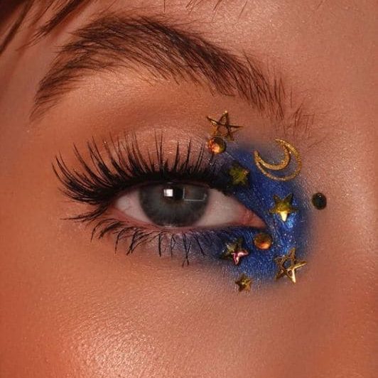 Maquiagem com aplicações de estrelas e luas