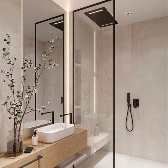 Modelo de banheiro minimalista com box com moldura preta, bancada em madeira decorada com vaso de planta e pia branca