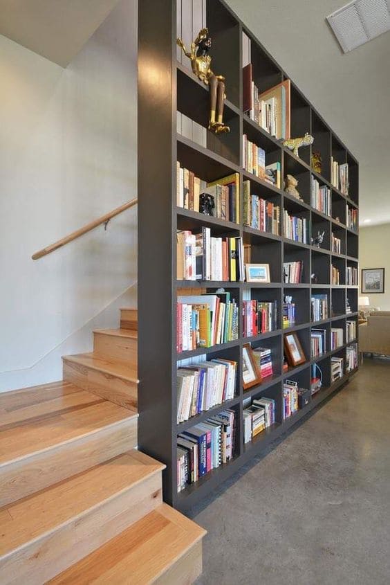 Estante próxima a escada cheia de livros