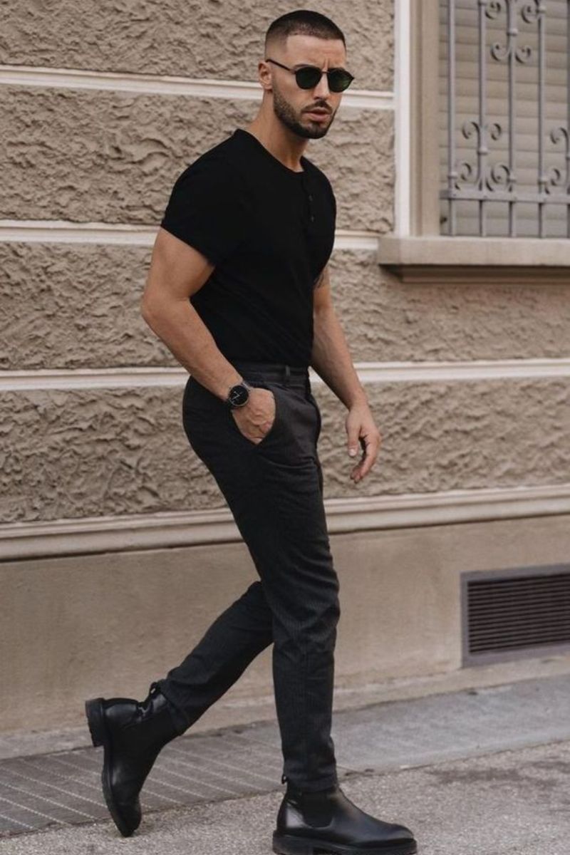 Homem usando um look de inverno masculino all black com bota