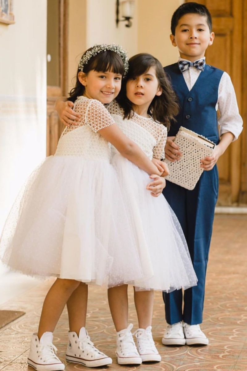 Duas meninas e um menino todos usando um look infantil com All Star num casamento