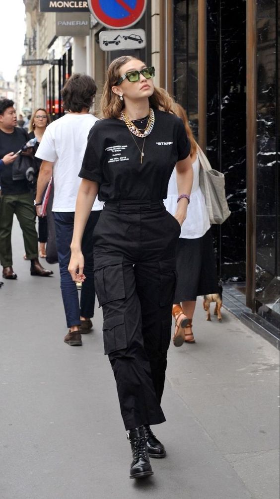 Mulher usando um look com coturno composto por calça cargo de cor preta
